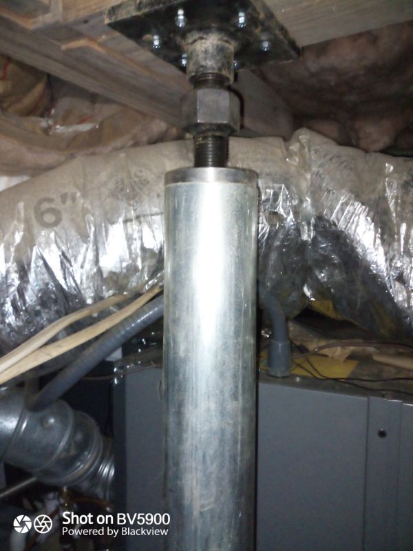 Adjustable steel support post threaded to a plate under the floor framing