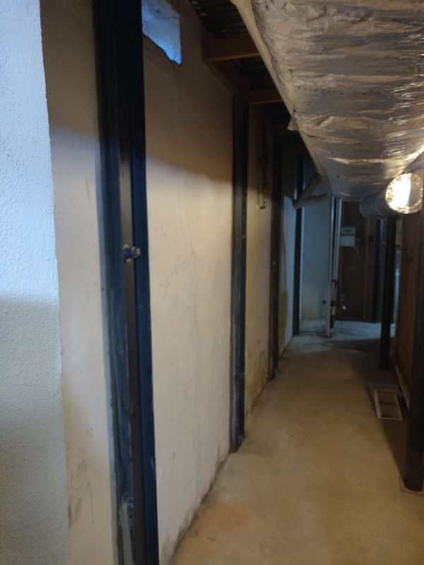 Steel wall beams installed along basement walls